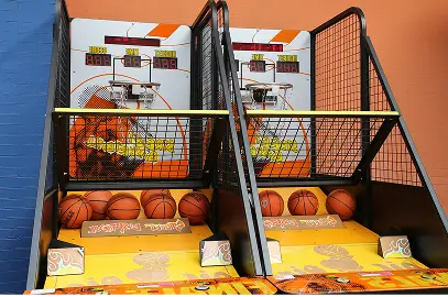 Basketball arcade game setup with bright yellow and orange theme.