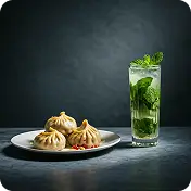 "Veg momos on a white plate with a glass of mojito at Kyra Food Street Chennai"